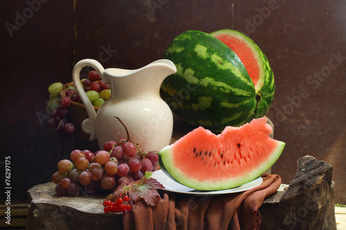 Water-melon, grapes, guelder-rose and white jug photo