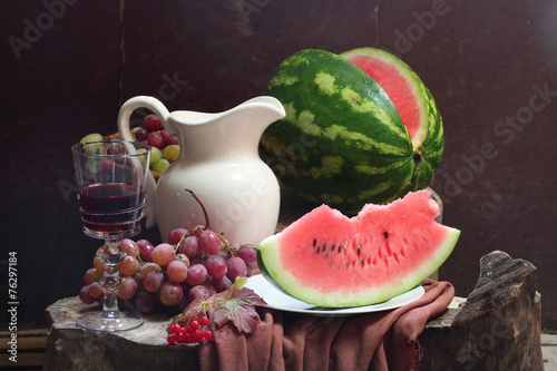 Wine, water-melon, grapes, guelder-rose and white jug photo