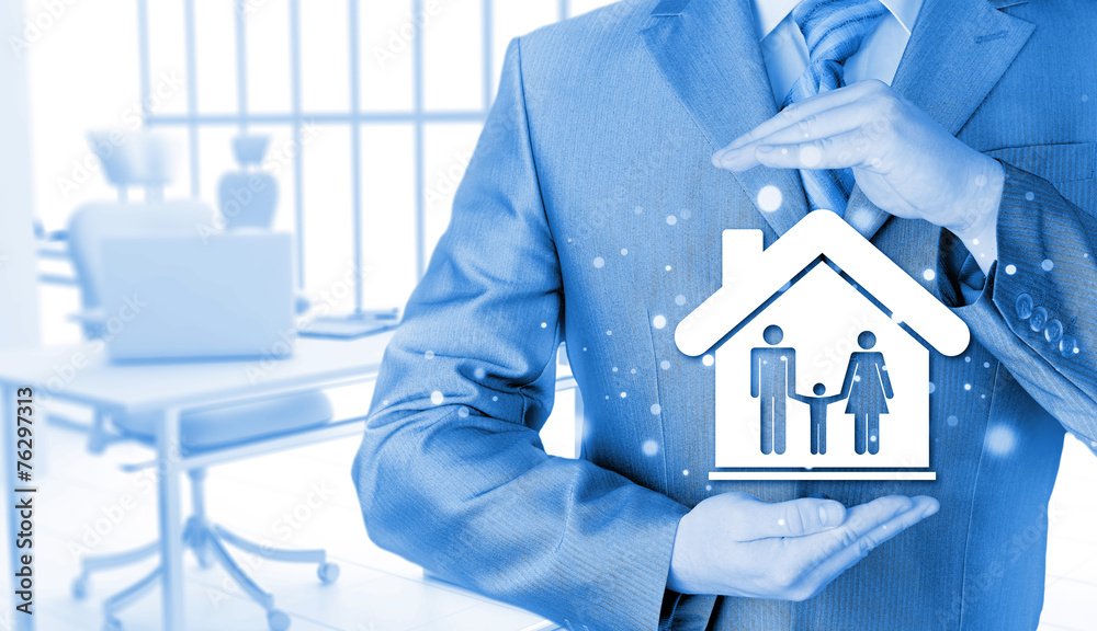 businessman protecting family in home with hands businessman protecting family in home with hands