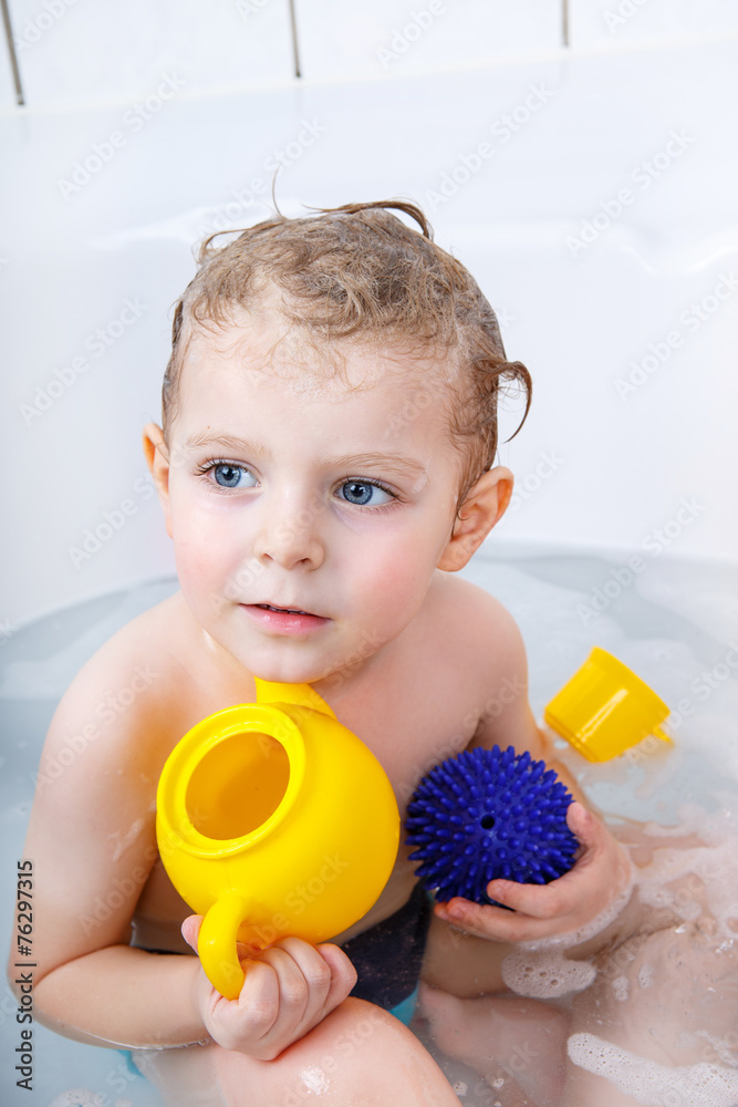 Adorable toddler boy having fun in bathtub Adorable toddler boy having fun in bathtub