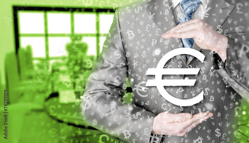 businessman protecting euro symbol