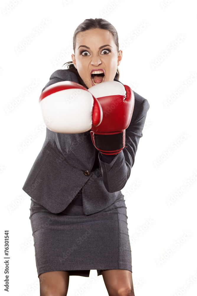 Front view of angry business woman, attack with boxing gloves Front view of angry business woman, attack with boxing gloves