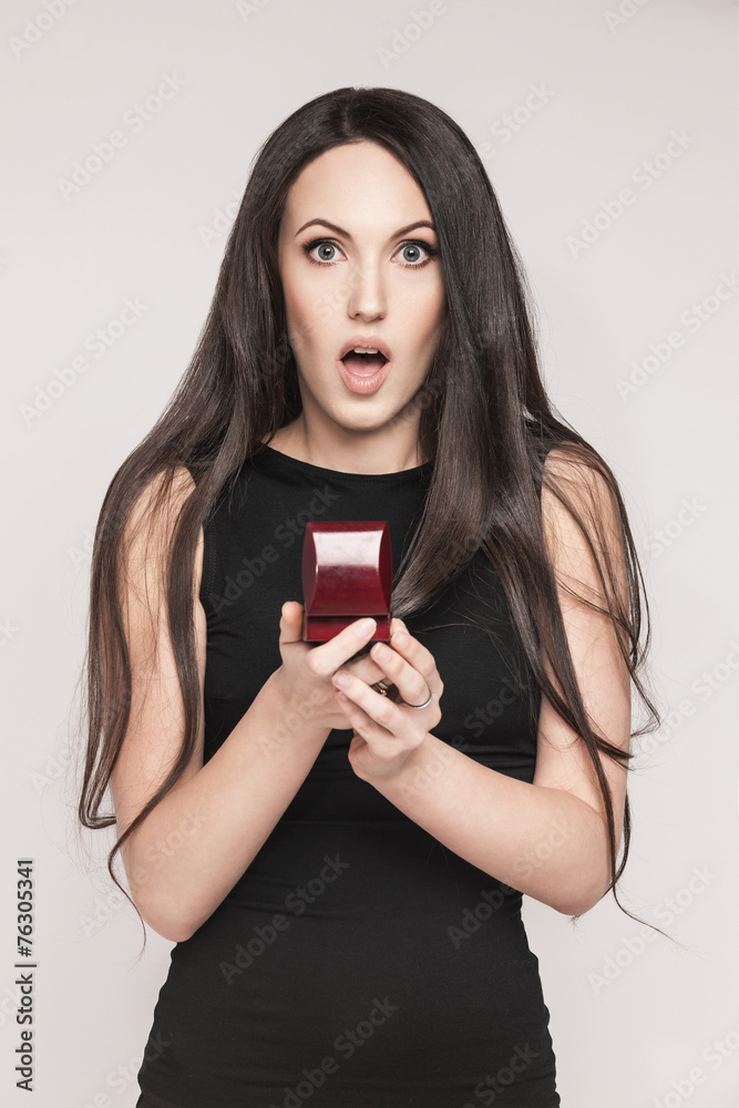 Naklejka premium Surpriced woman holding jewelry box