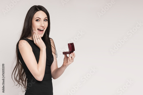 Surpriced woman holding jewelry box