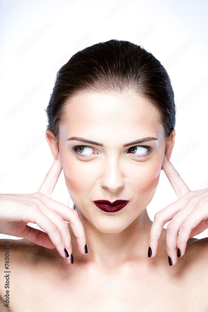 Beauty portrait of a cute woman closed ears by her hands