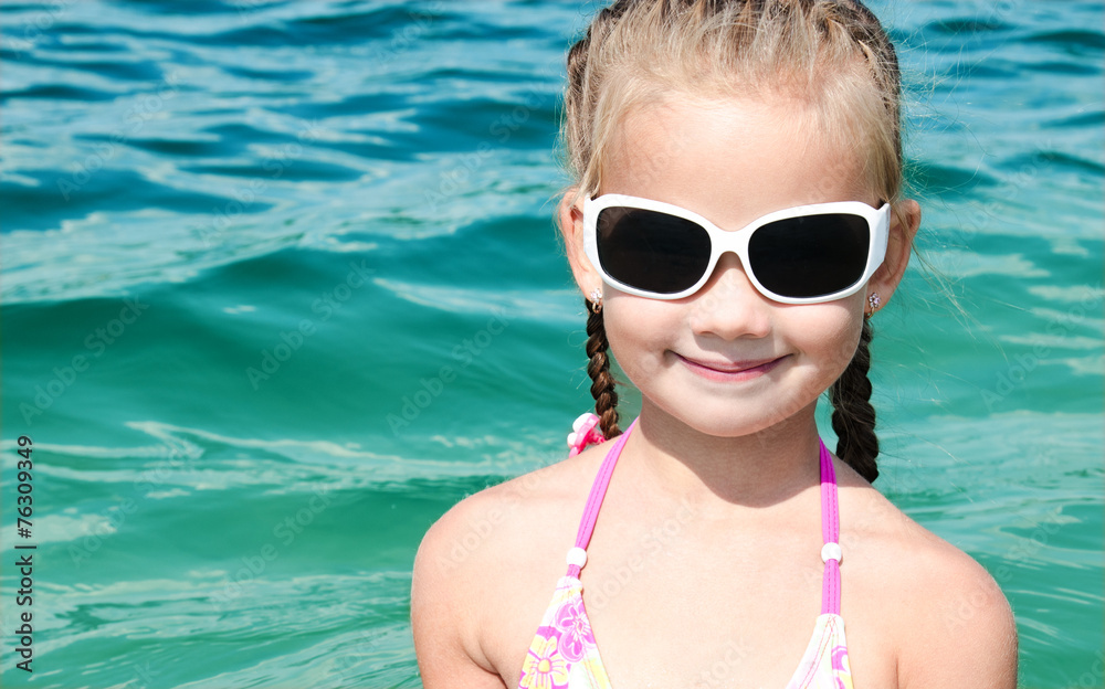 Adorable smiling little girl on beach vacation Adorable smiling little girl on beach vacation