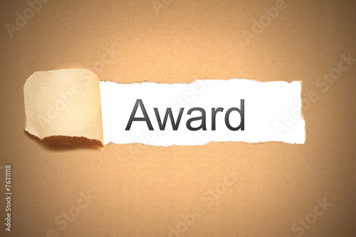 brown paper torn to reveal award