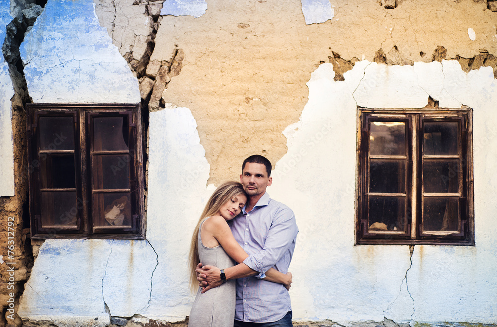 Couple in love in front of an old house