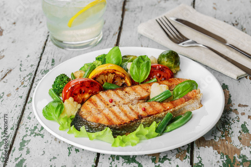 steak grilled salmon with vegetables on a plate