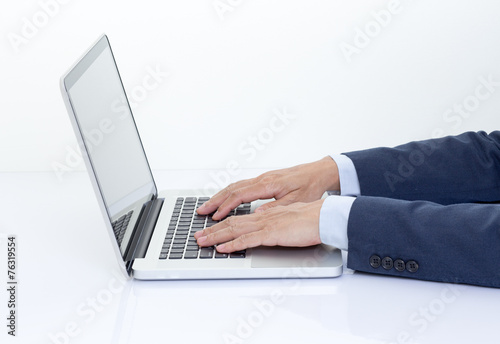 Businessman hands typing on laptop computer