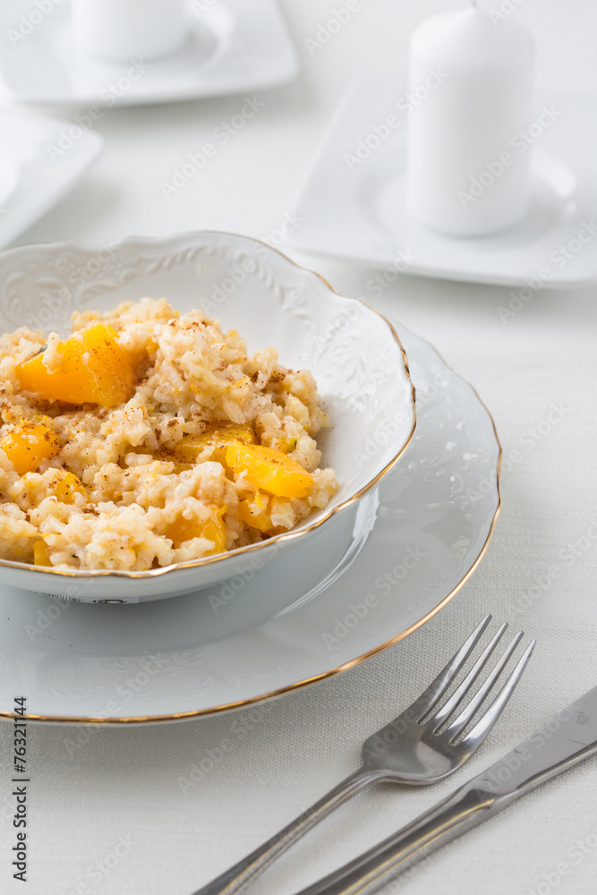 risotto with pumpkin in white bowl