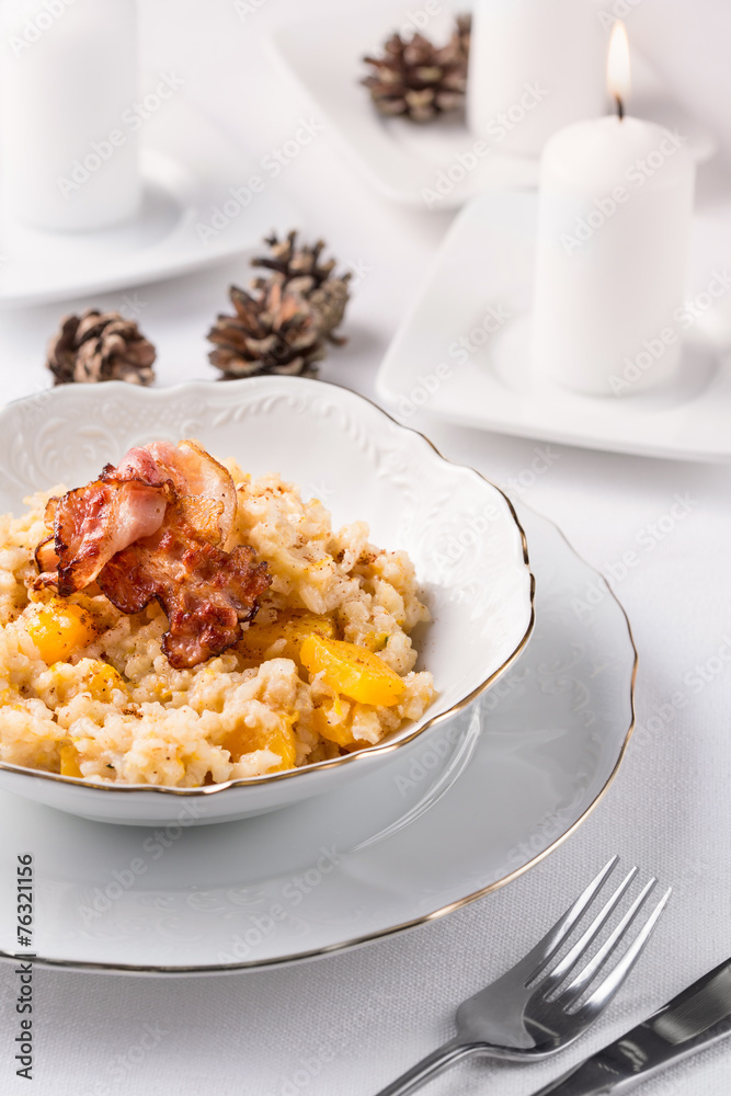 risotto with pumpkin and bacon in white bowl risotto with pumpkin and bacon in white bowl