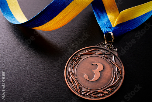 Bronze medal on a dark background photo