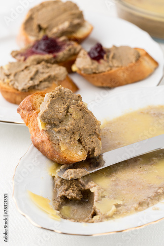 small bread pieces with homemade pate on white plate