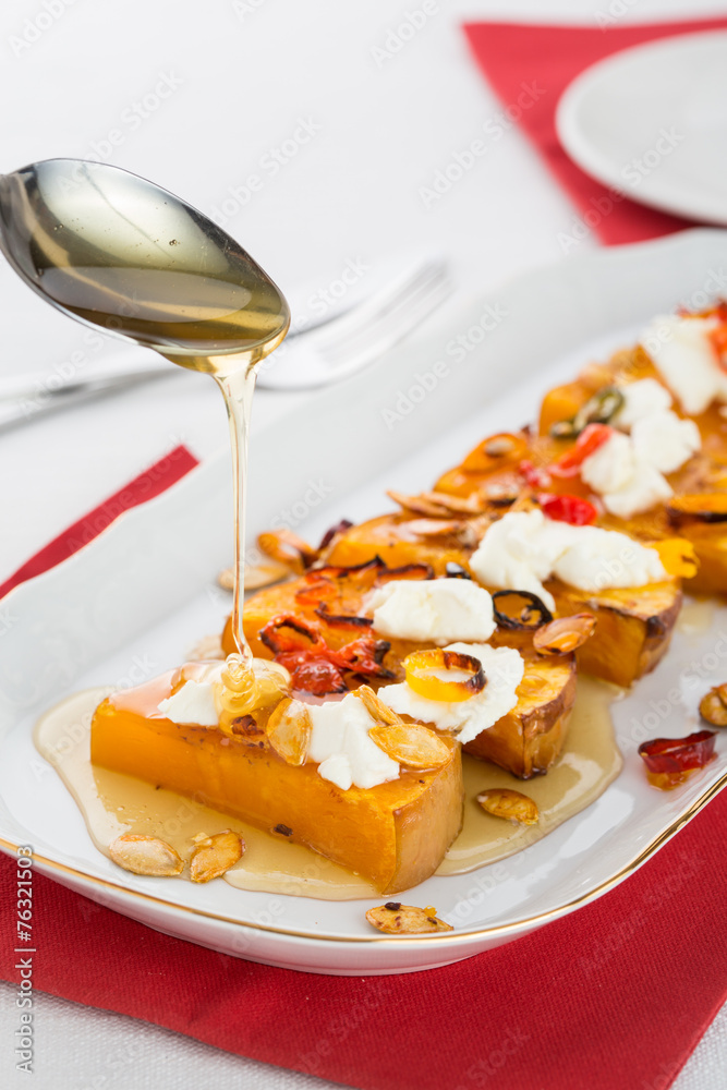 baked pumpkin slices with seeds and honey