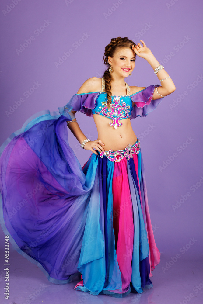 Beautiful belly dancer wearing a purple costume