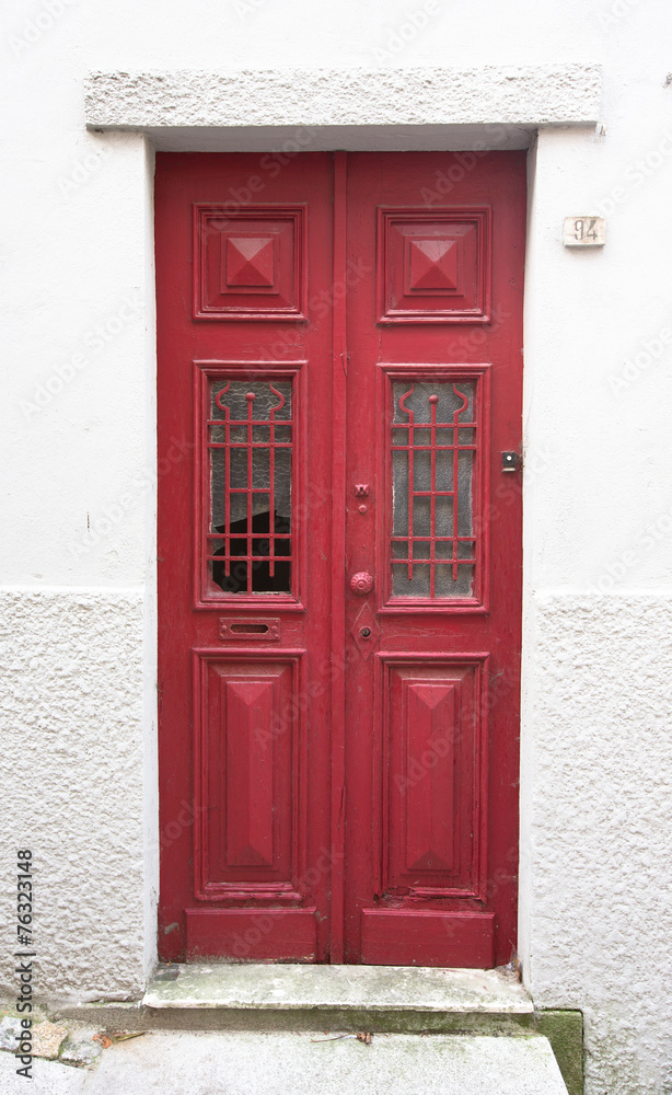 Fototapeta premium Old red wooden door with window and grid