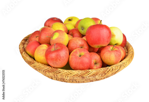 Red apple in a wattled basket, isolated on white background