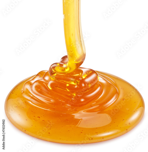 Honey flowing on the white background.