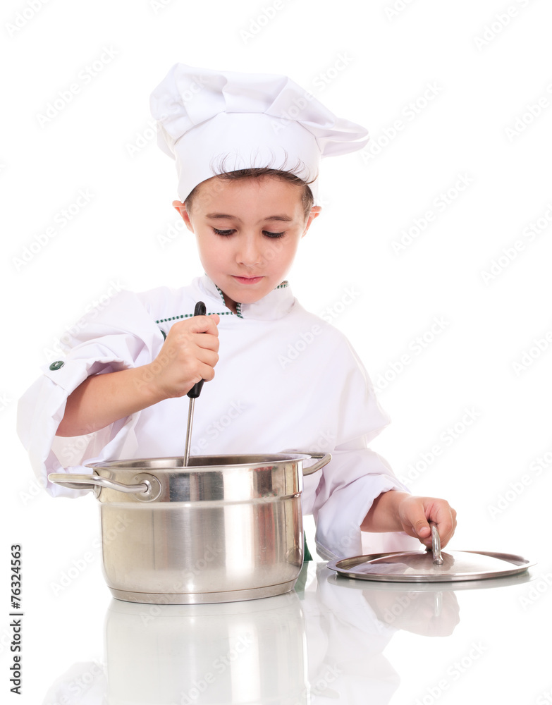 Little boy chef with ladle stiring in the pot Little boy chef with ladle stiring in the pot