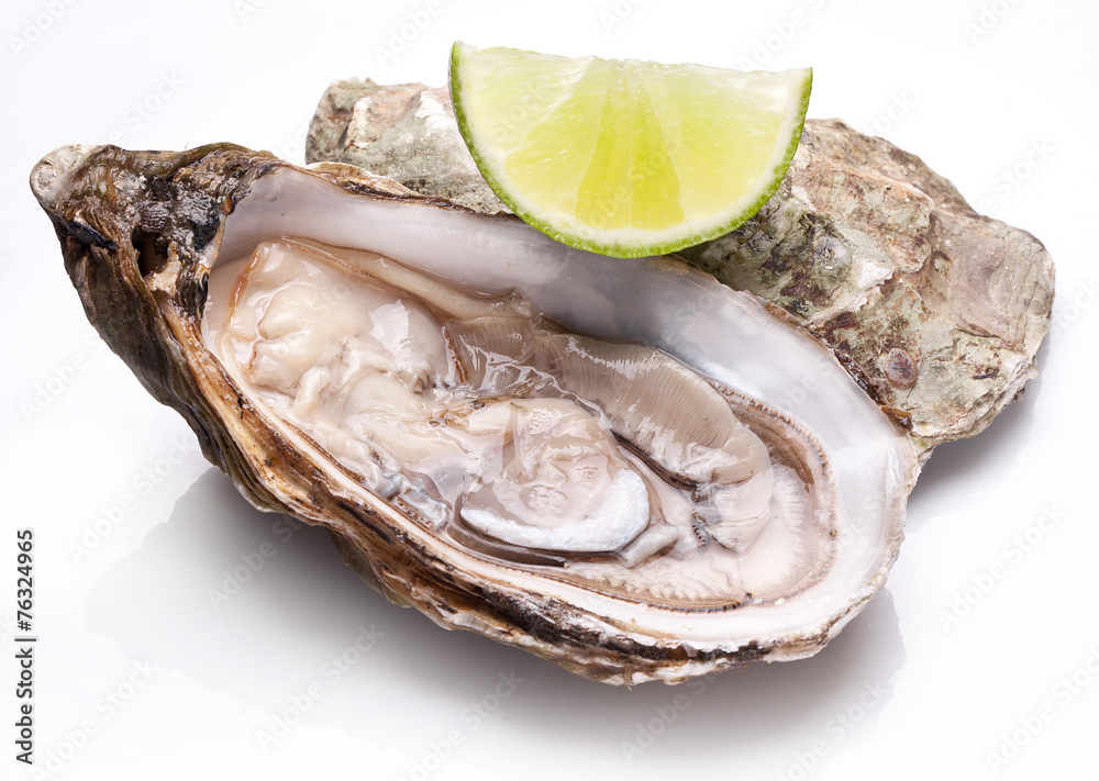 Raw oyster and lemon on a whte background. Raw oyster and lemon on a whte background.