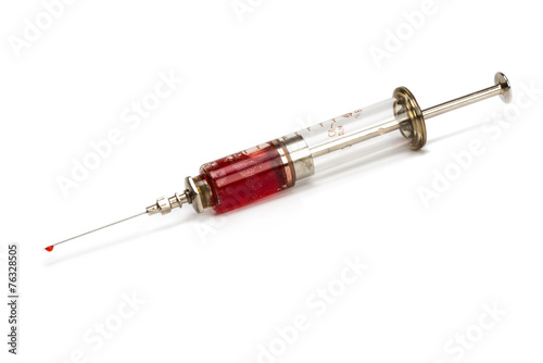 medical syringe made of glass and metal with blood