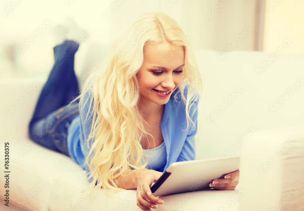 smiling woman with tablet pc computer at home