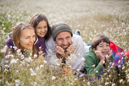 Familia tumbada en el campo photo