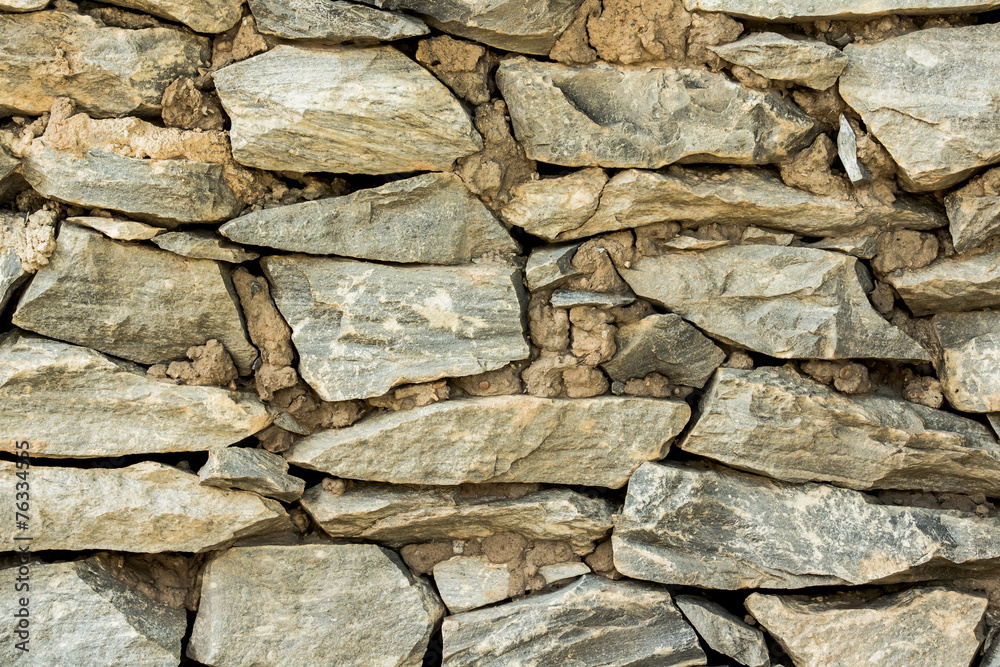 Cracked real stone wall surface with cement. Cracked real stone wall surface with cement.