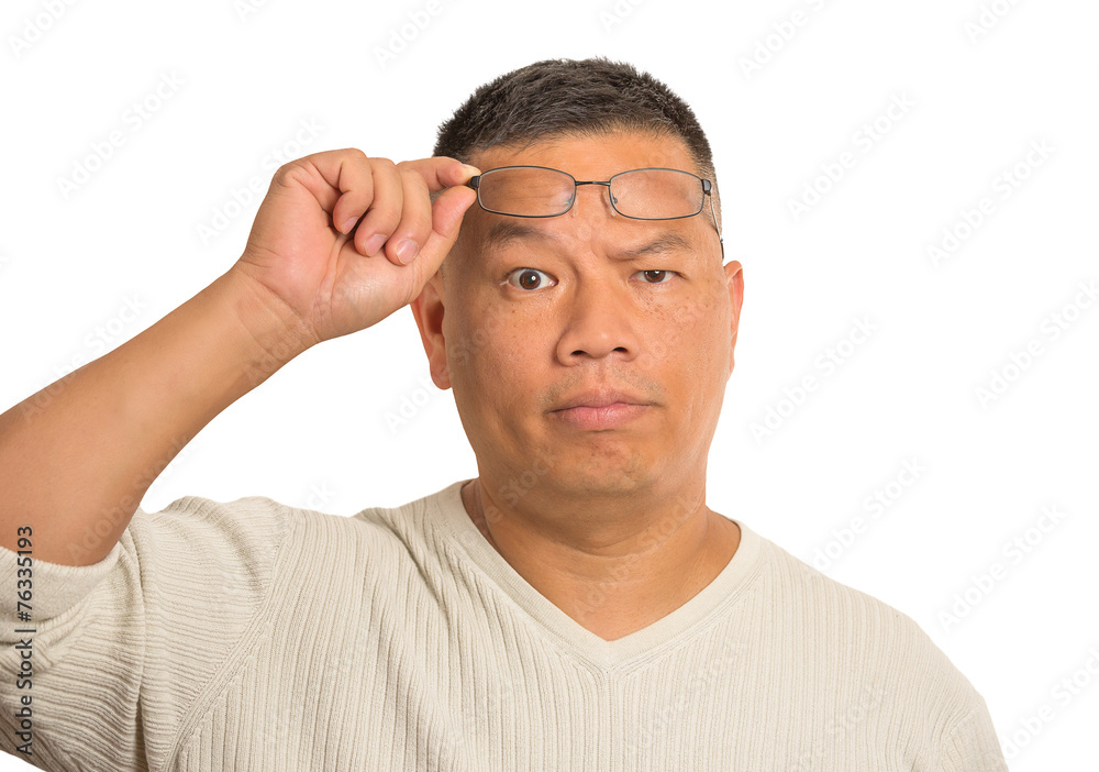 serious middle aged man with glasses skeptically looking at you serious middle aged man with glasses skeptically looking at you