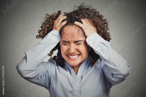 Frustrated stressed young woman having headache bad day