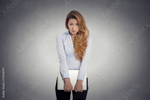  Insecure worried young woman holding laptop feels awkward