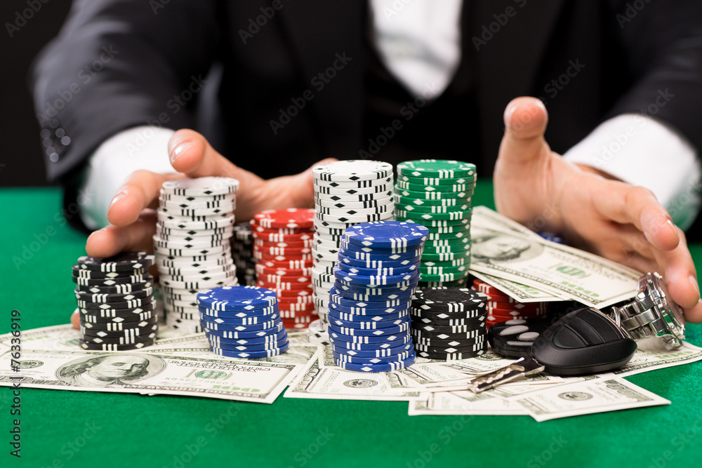 poker player with chips and money at casino table poker player with chips and money at casino table