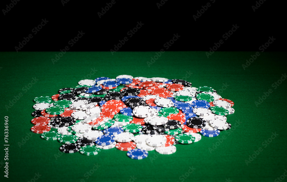 close up of casino chips on green table surface close up of casino chips on green table surface