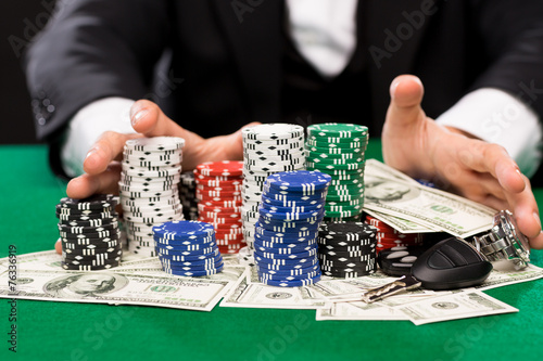Fotografie poker player with chips and money at casino table