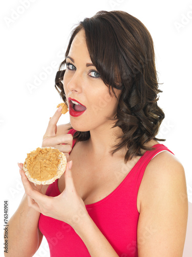 Young Woman Eating Peanut Butter on a Cracker