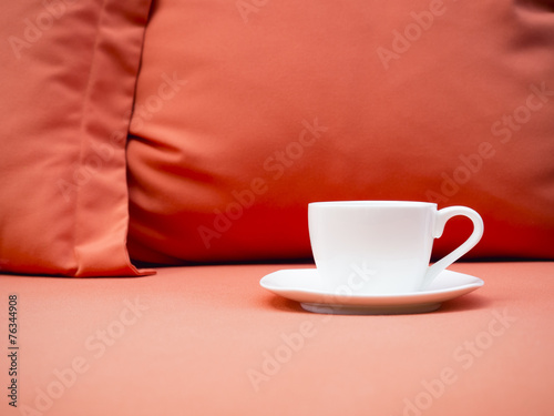 Cup of coffee on Sofa with Pillow