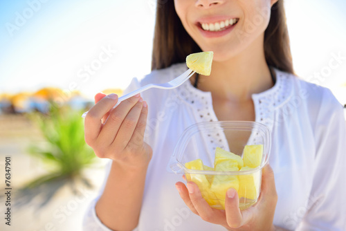Pineapple - woman eating sliced Hawaiian fruit