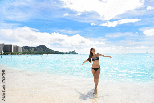 Happy beach woman in bikini on Waikiki Oahu Hawaii
