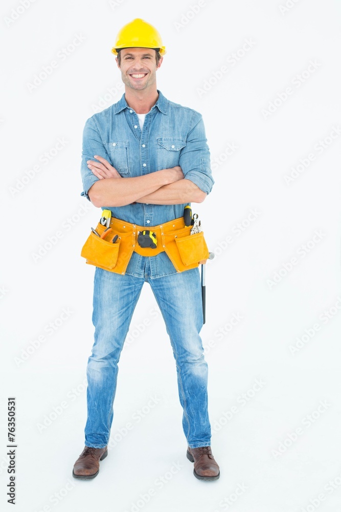 Carpenter standing arms crossed over white background Carpenter standing arms crossed over white background