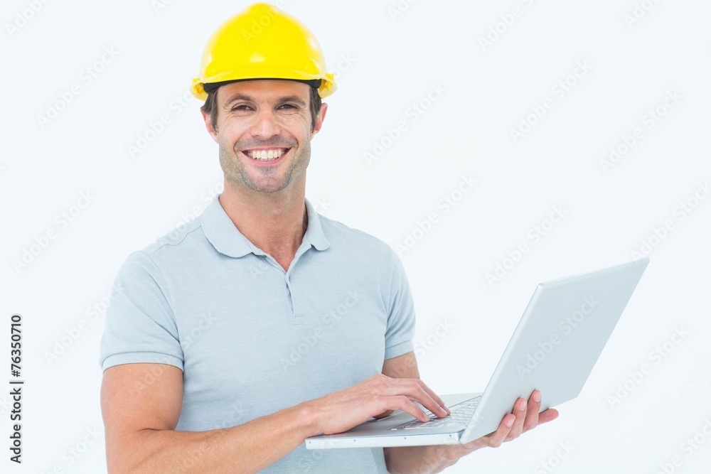 Carpenter using laptop over white background Carpenter using laptop over white background