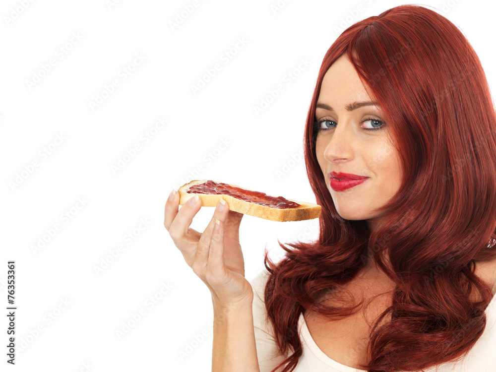 Young Woman Eating Strawberry Jam on Toast Young Woman Eating Strawberry Jam on Toast