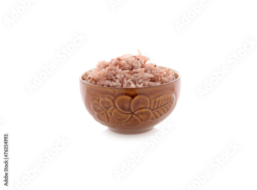 cooked red rice in bowl on white background