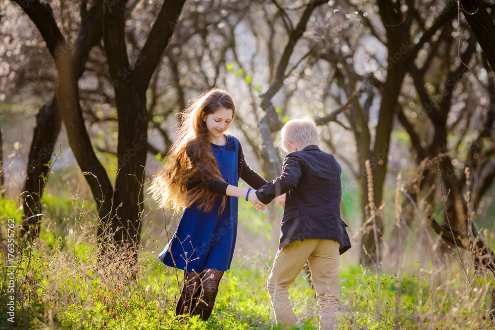 children walk in the park in spring children walk in the park in spring