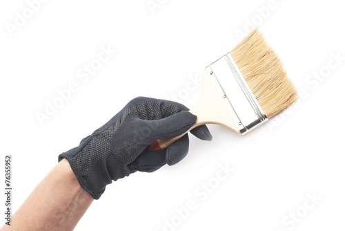 Hand holding a paint brush, isolated