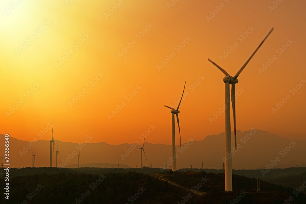 Wind turbines with power line in the sunset Wind turbines with power line in the sunset