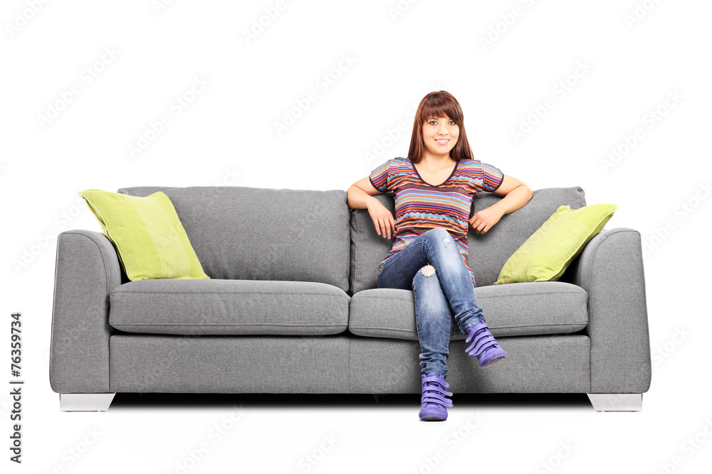 Relaxed woman sitting on a modern sofa
