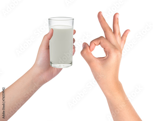 Hand holding glass of milk