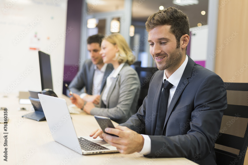 Businessman on mobile phone in office, sms, message Businessman on mobile phone in office, sms, message