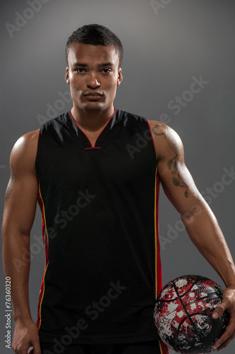 Young handsome African man posing with basketball ball